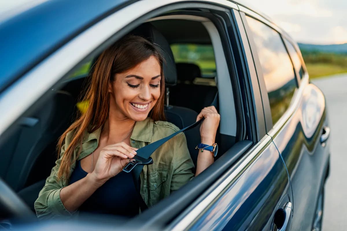 Vrouw in haar auto, glimlachend